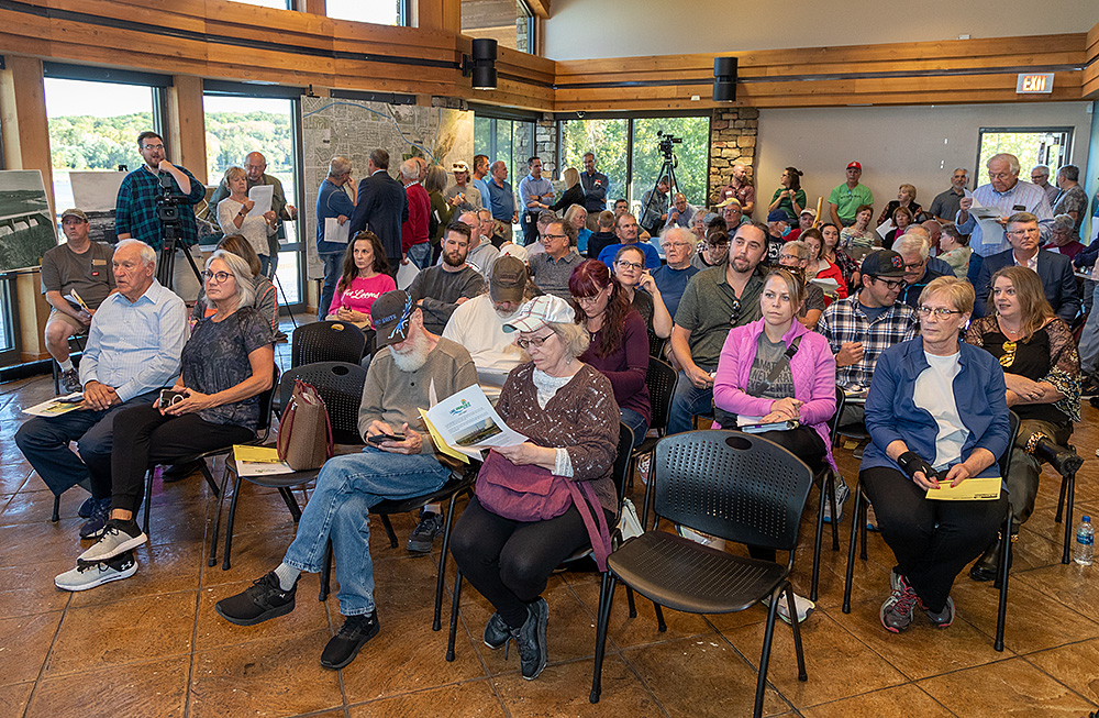 crowd of around 100 people seated in the lake springfield boat house