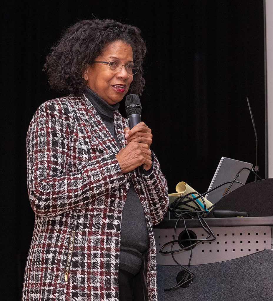 francine pratt speaking with a handheld microphone